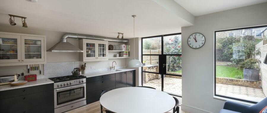 Wide panoramic image of modern kitchen with crittall windows.