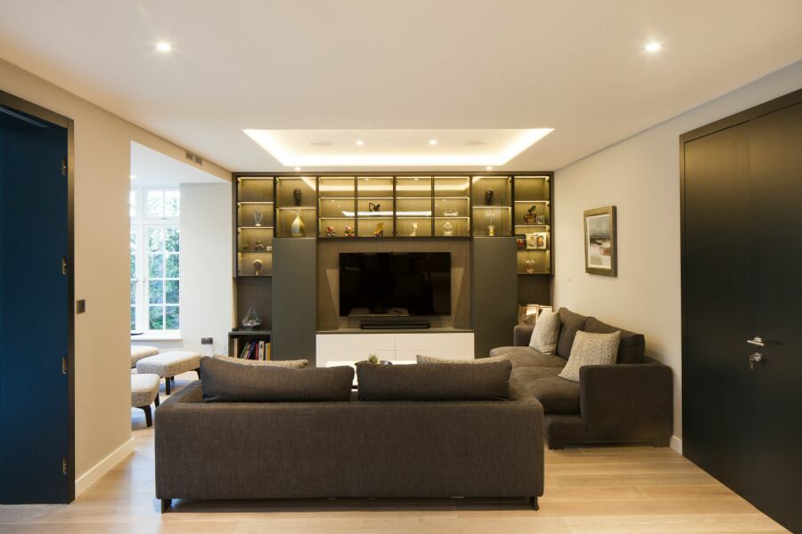 Modern living room with light walls and dark doors .