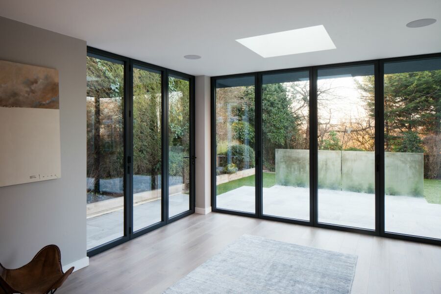 Modern room with full height doors leading to garden.