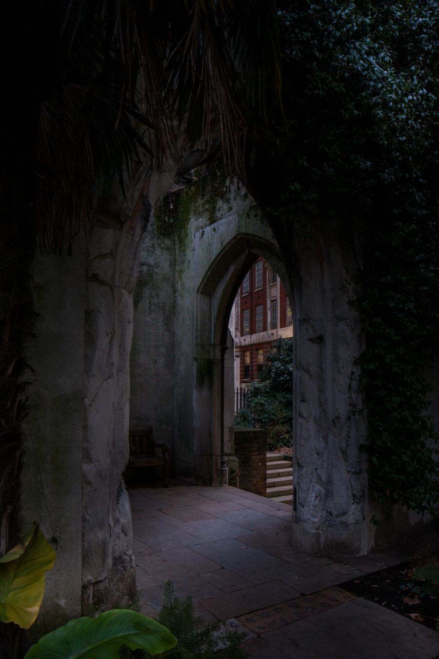 dark view of  St Dunstan's church with foliage.